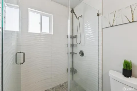 a bathroom with a shower and a shower