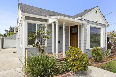 front view of a house with potted plants