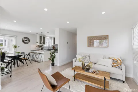 a living room with furniture and kitchen view