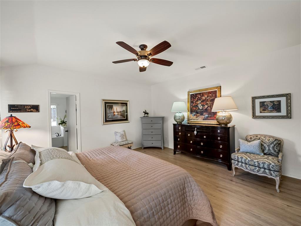 204 Arbor Ridge Drive Allen, TX 75002 - Photo 16 of 36 Spacious bedroom with vaulted ceilings, wood-finish flooring, and a ceiling fan