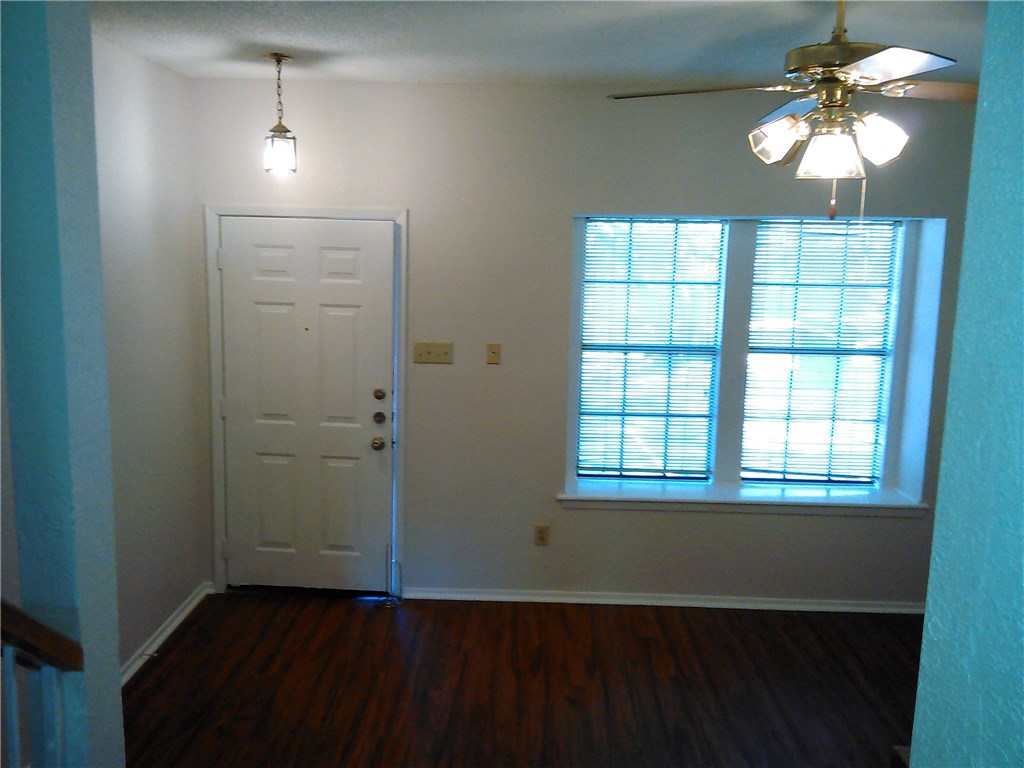 11821 Bittern Hollow, Unit 20 Austin, TX 78758 - Photo 2 of 14 an empty room with wooden floor and windows