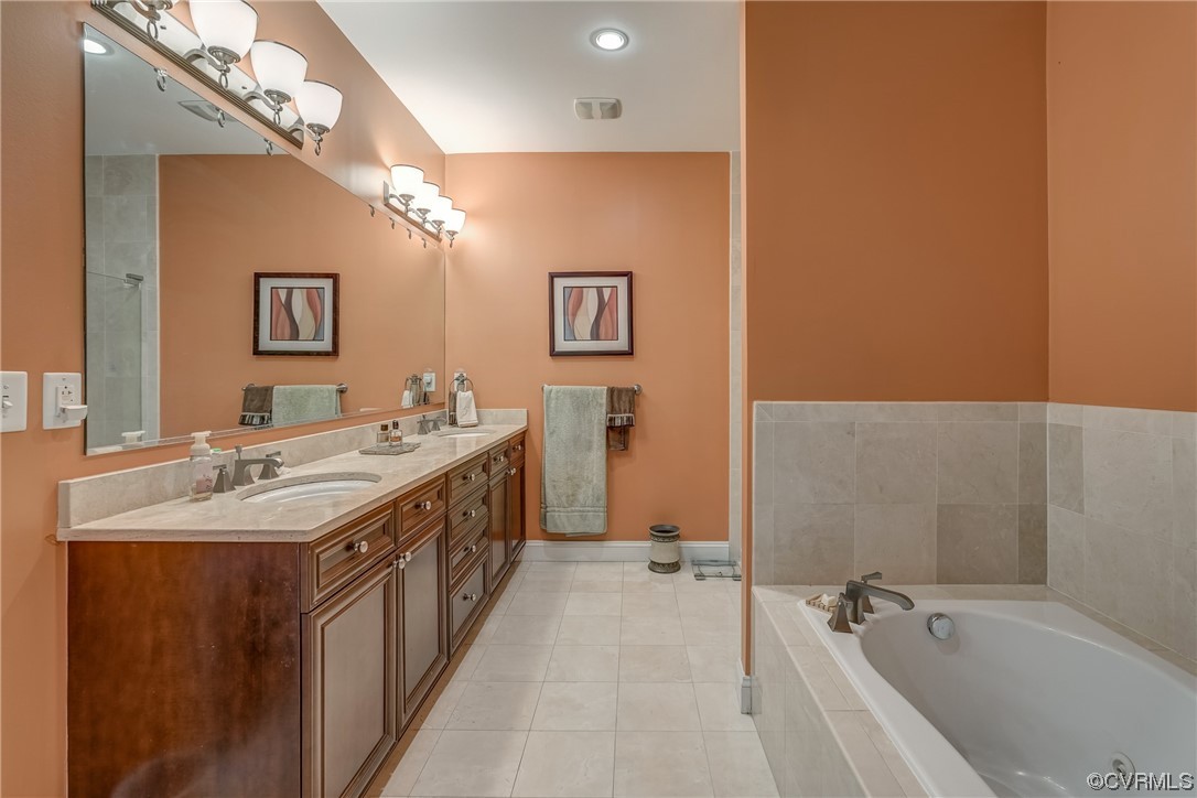 116 Cedar Works Row Richmond, VA 23231 - Photo 12 of 21 a spacious bathroom with a double vanity sink a mirror and a bathtub