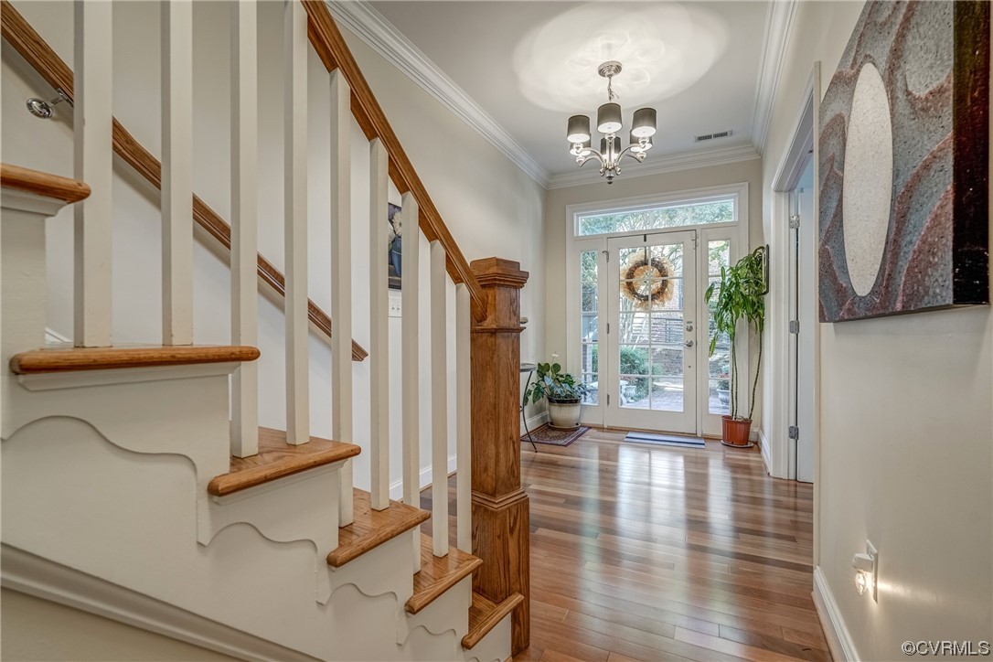 116 Cedar Works Row Richmond, VA 23231 - Photo 2 of 21 a view of a hallway with wooden floor and chandelier