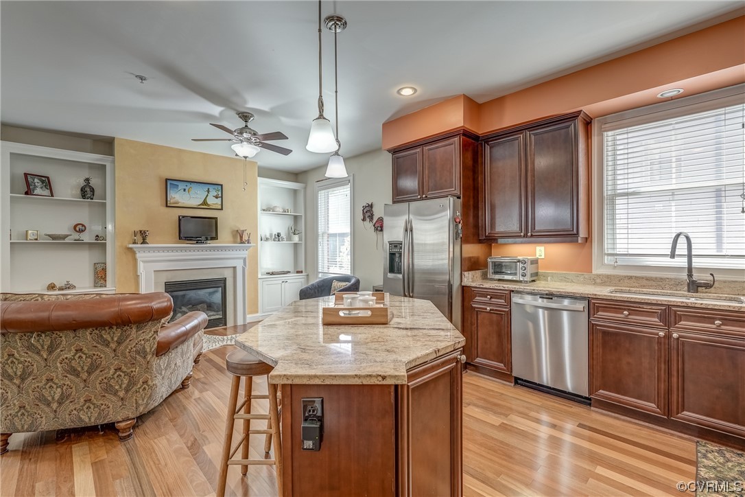 116 Cedar Works Row Richmond, VA 23231 - Photo 4 of 21 a kitchen with granite countertop kitchen island stainless steel appliances a sink stove and refrigerator