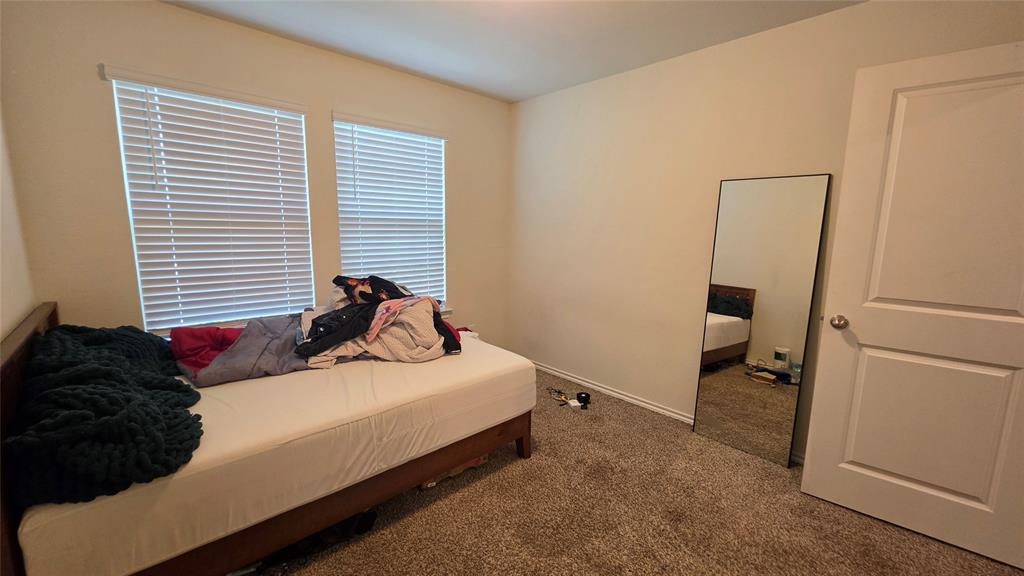 409 Samuel Street Denton, TX 76207 - Photo 6 of 40 a bedroom with a bed and a window
