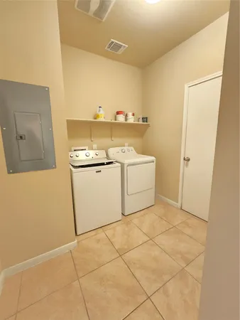 a kitchen with stainless steel appliances granite countertop a refrigerator and a view of living room