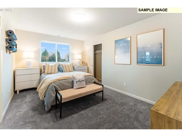 a bedroom with a bed and a painting on the wall