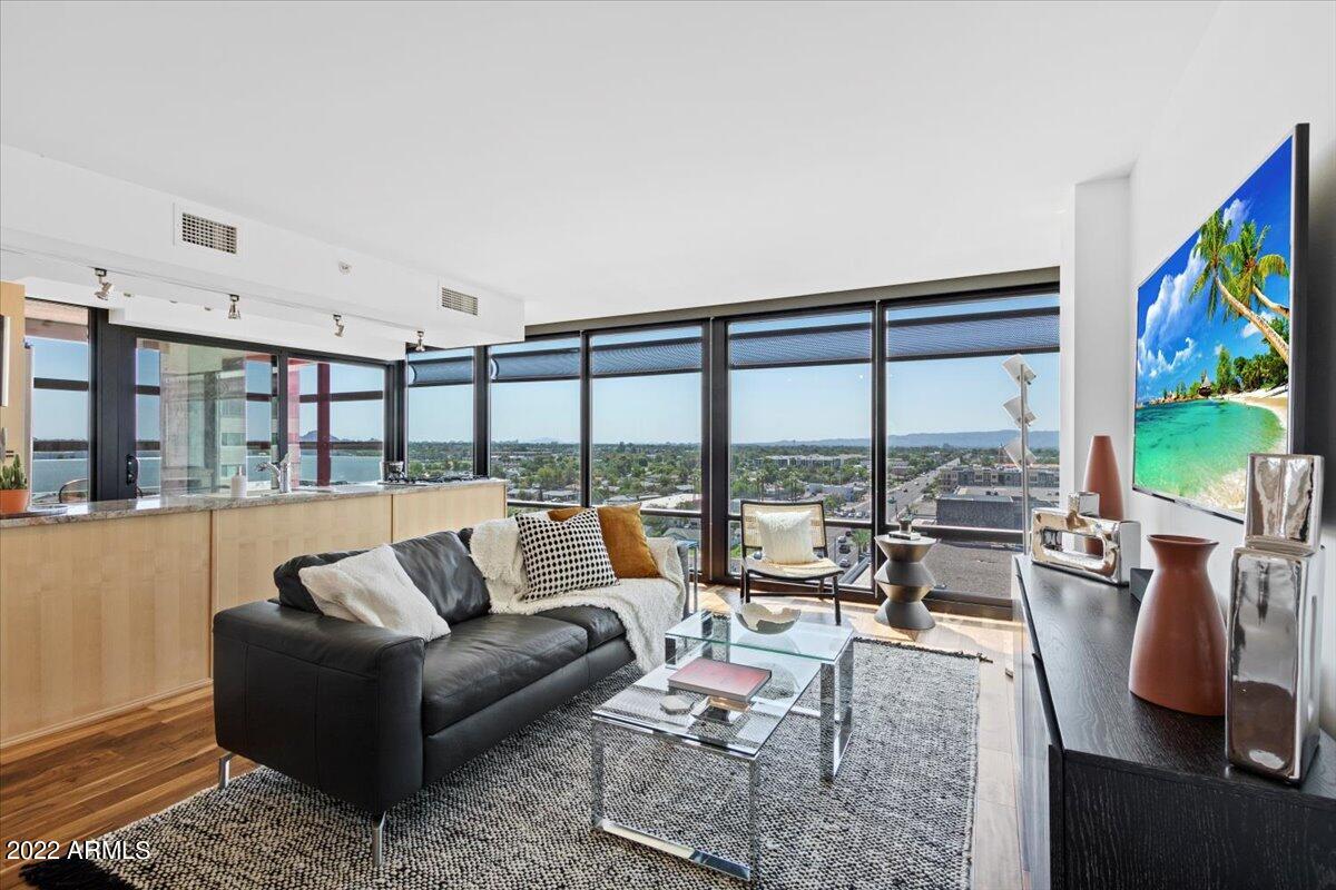 4808 North 24th Street, Unit 1007 Phoenix, AZ 85016 - Photo 1 of 19 a living room with furniture large windows and a flat screen tv