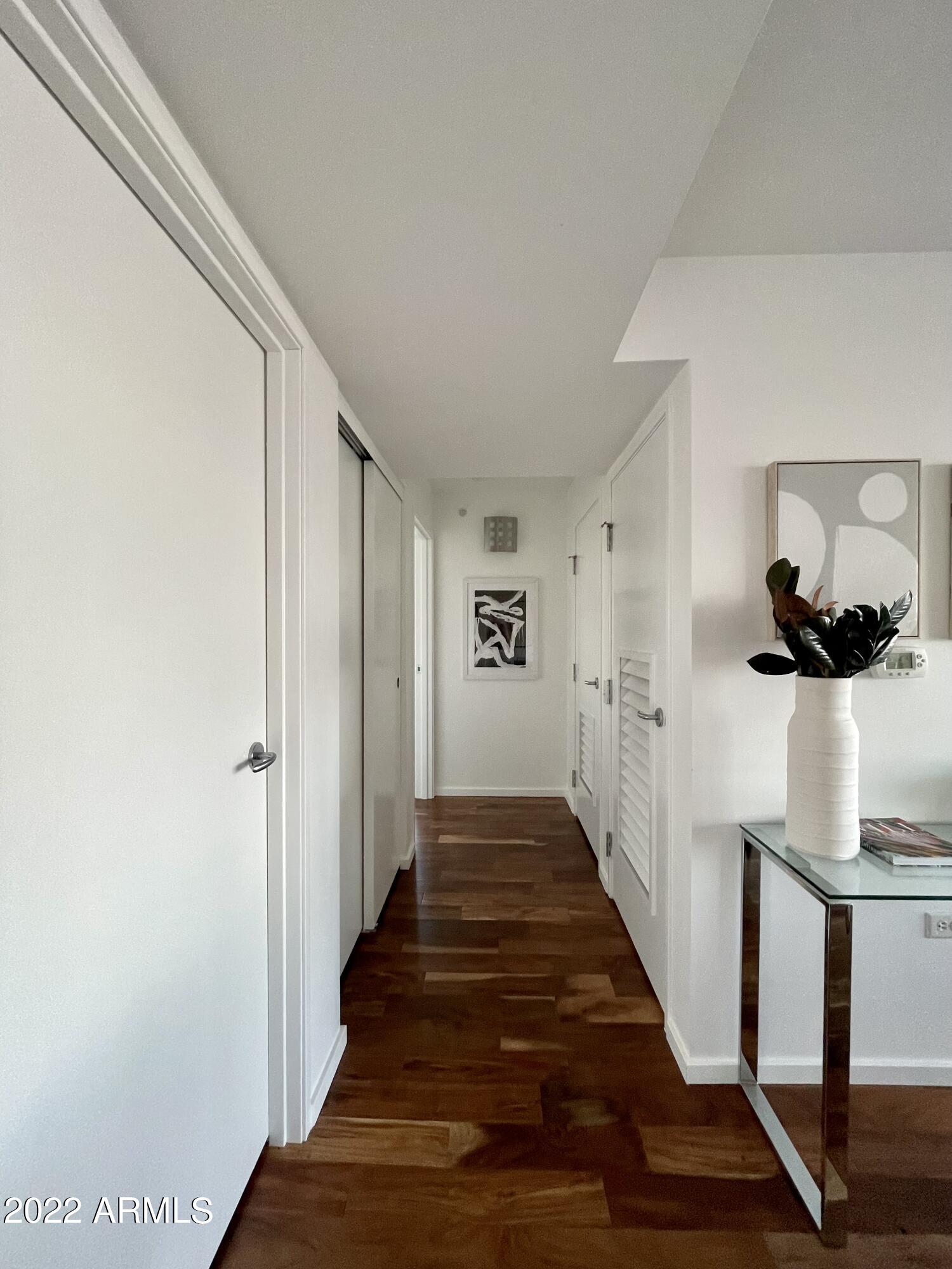 4808 North 24th Street, Unit 1007 Phoenix, AZ 85016 - Photo 17 of 19 a view of a hallway with wooden floor and staircase