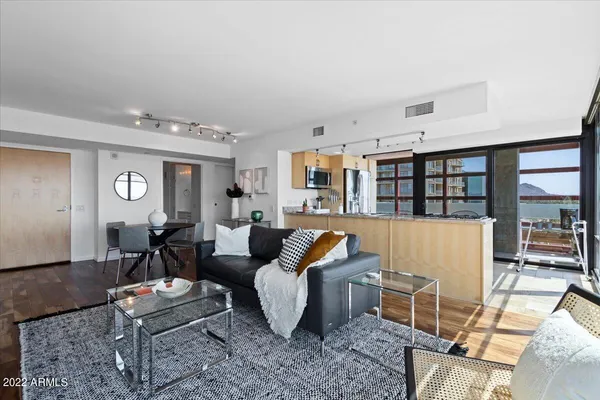 a living room with furniture and wooden floor