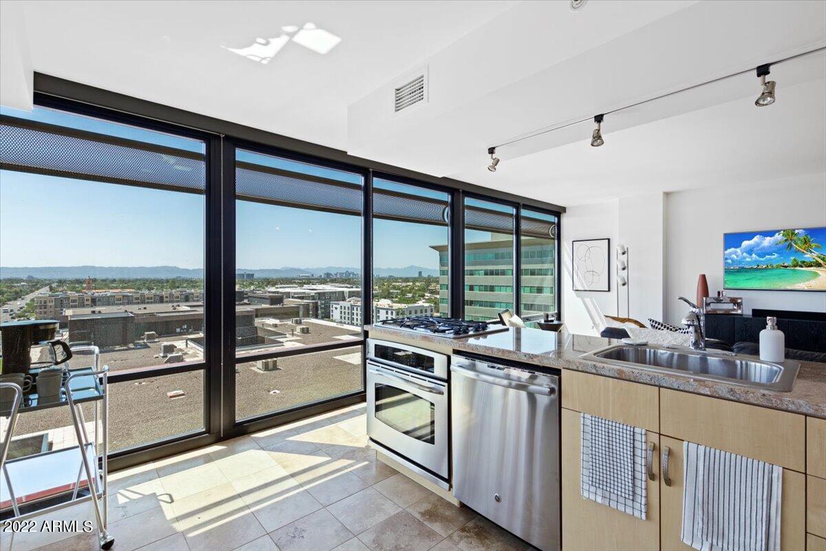4808 North 24th Street, Unit 1007 Phoenix, AZ 85016 - Photo 4 of 19 a kitchen with counter top oven stove and sink