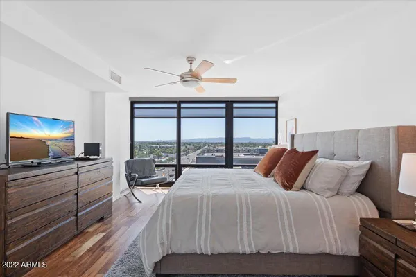 a bedroom with a bed and a flat screen tv