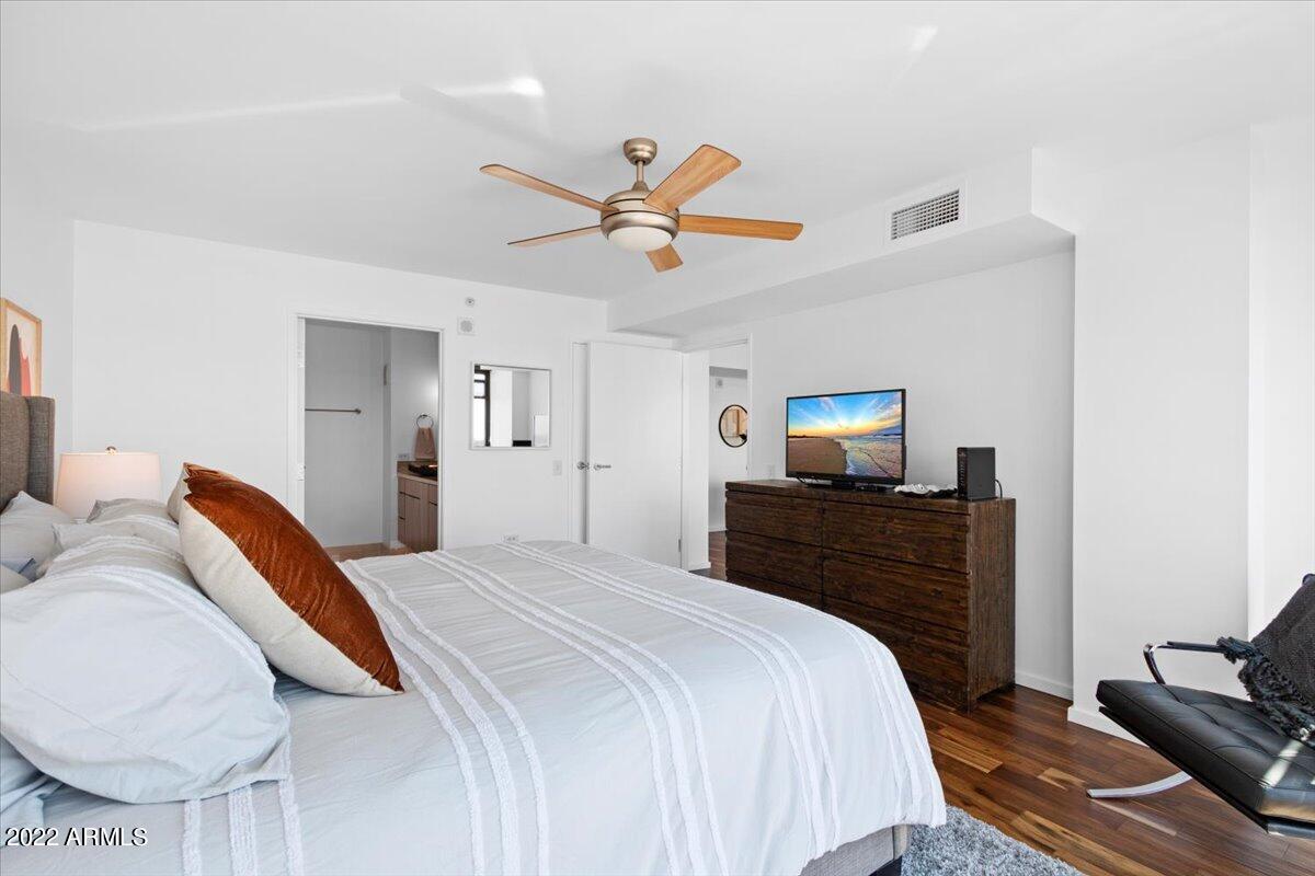 4808 North 24th Street, Unit 1007 Phoenix, AZ 85016 - Photo 7 of 19 a bedroom with a bed and wooden floor