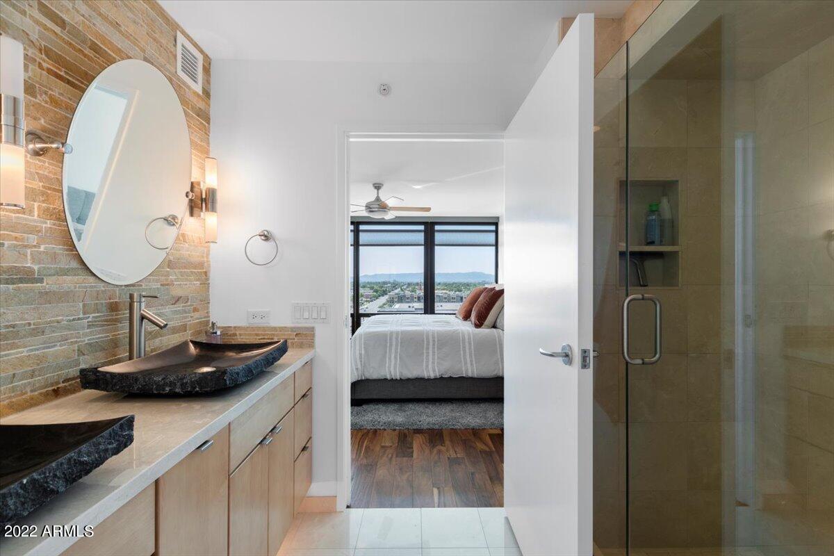 4808 North 24th Street, Unit 1007 Phoenix, AZ 85016 - Photo 9 of 19 a en suite bathroom with a granite countertop sink and a mirror