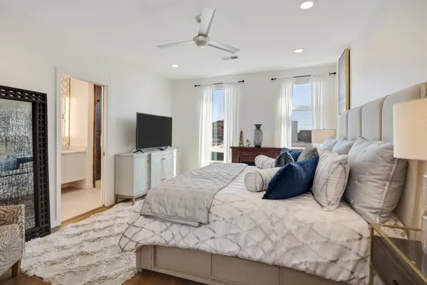 a bedroom with a bed and a flat screen tv