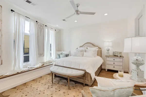 a spacious bedroom with a bed and a window