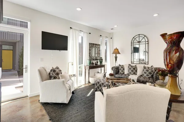 a living room with furniture fireplace and flat screen tv