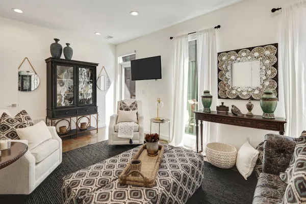 a bedroom with furniture and a large window