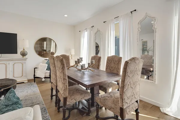 a view of a dining room with furniture and a wooden floor