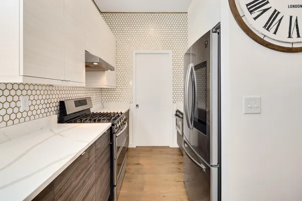a kitchen with a stove and a refrigerator