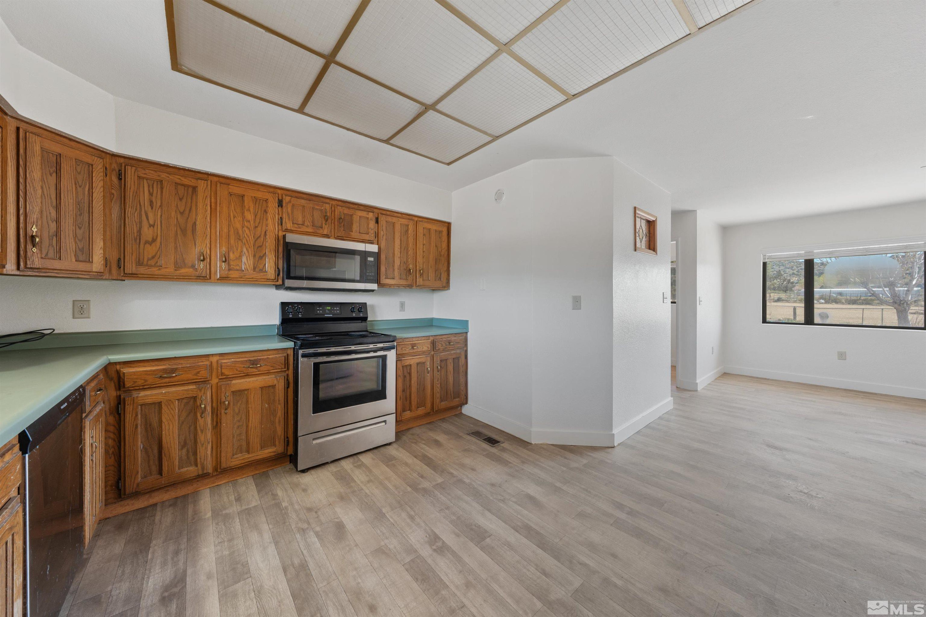 9320 Arrowhead Way Reno, NV 89506 - Photo 11 of 39 a kitchen with stainless steel appliances granite countertop a stove a sink and a refrigerator