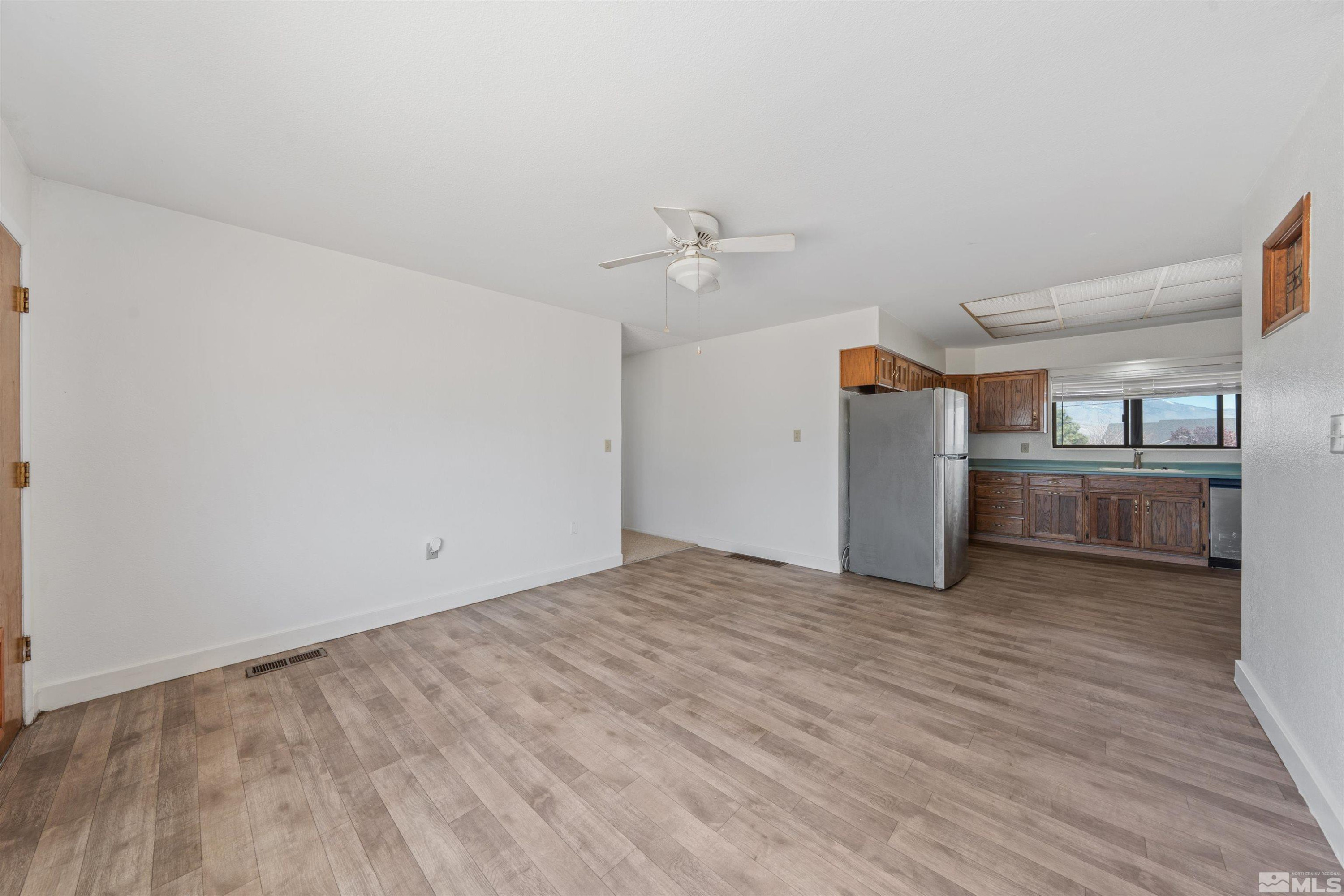 9320 Arrowhead Way Reno, NV 89506 - Photo 15 of 39 a view of empty room with wooden floor