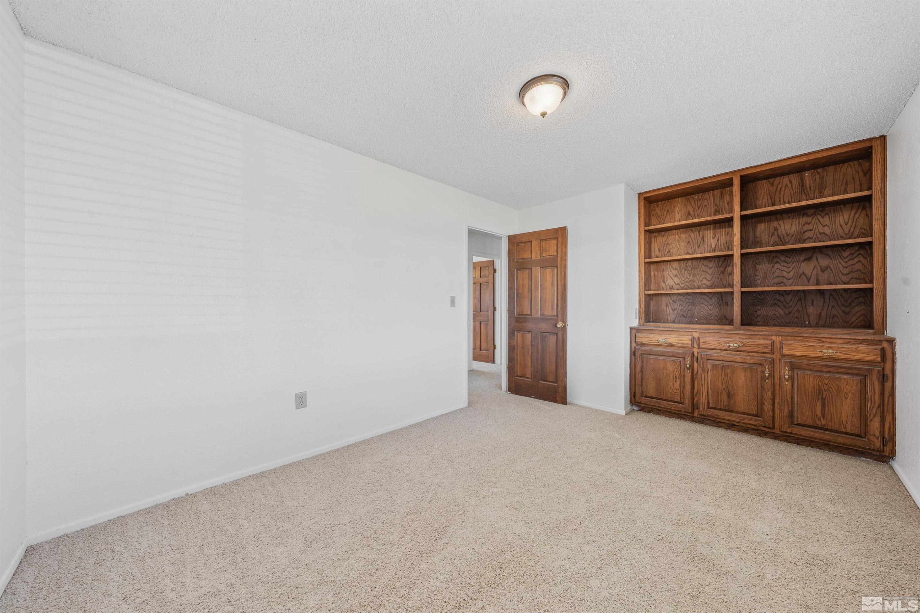 9320 Arrowhead Way Reno, NV 89506 - Photo 19 of 39 a view of an empty room with furniture and empty shelves