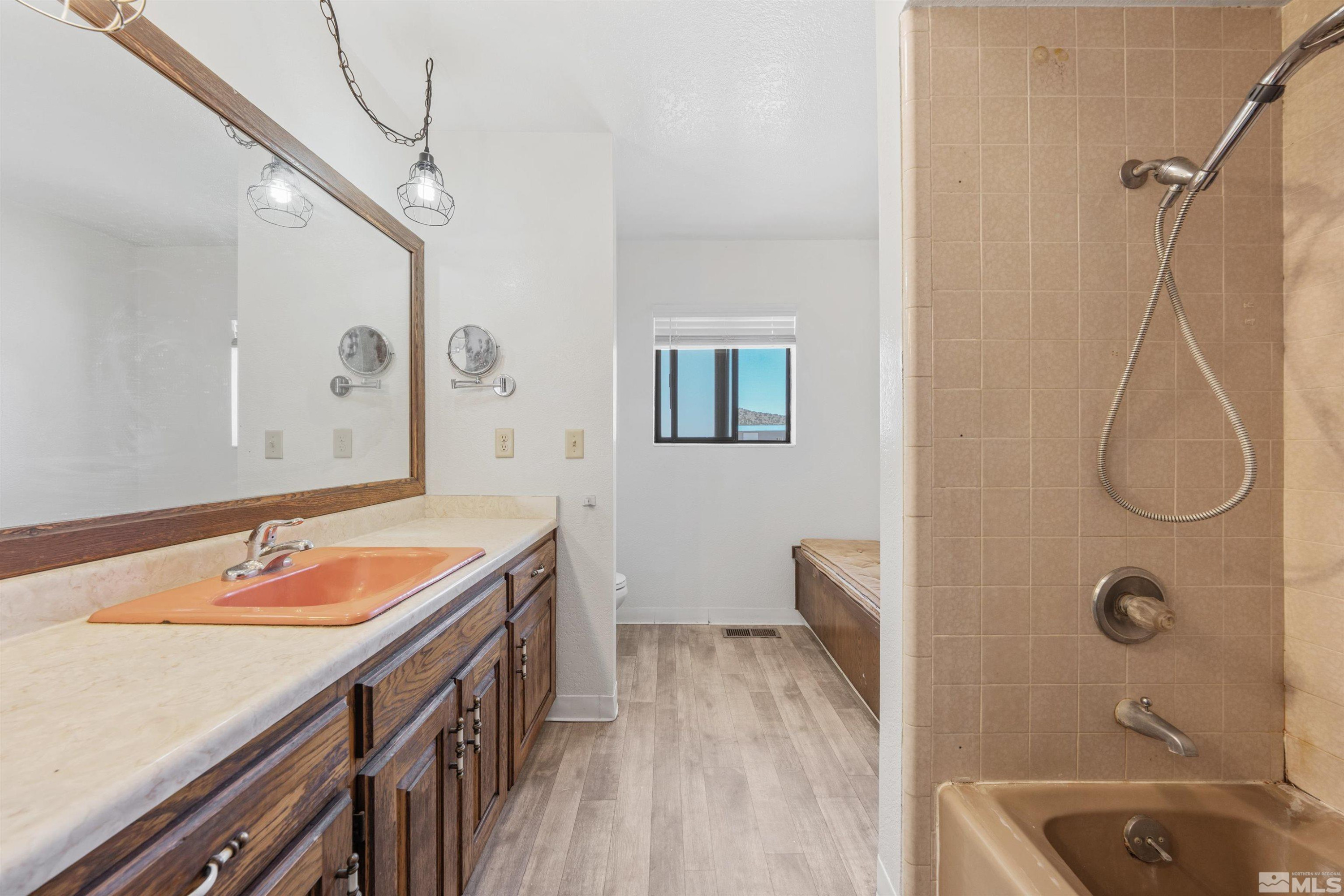 9320 Arrowhead Way Reno, NV 89506 - Photo 20 of 39 a bathroom with a tub sink and mirror