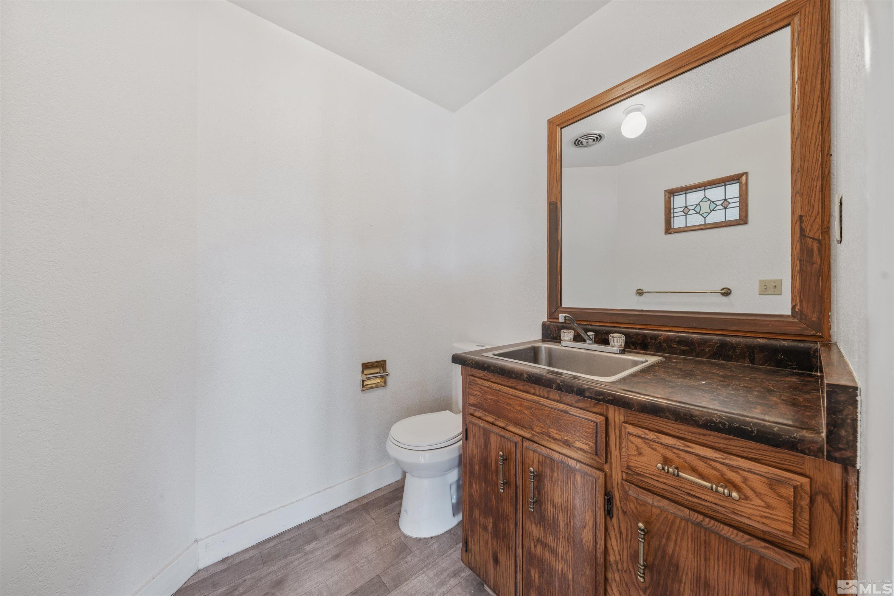 9320 Arrowhead Way Reno, NV 89506 - Photo 25 of 39 a bathroom with a granite countertop sink and a mirror