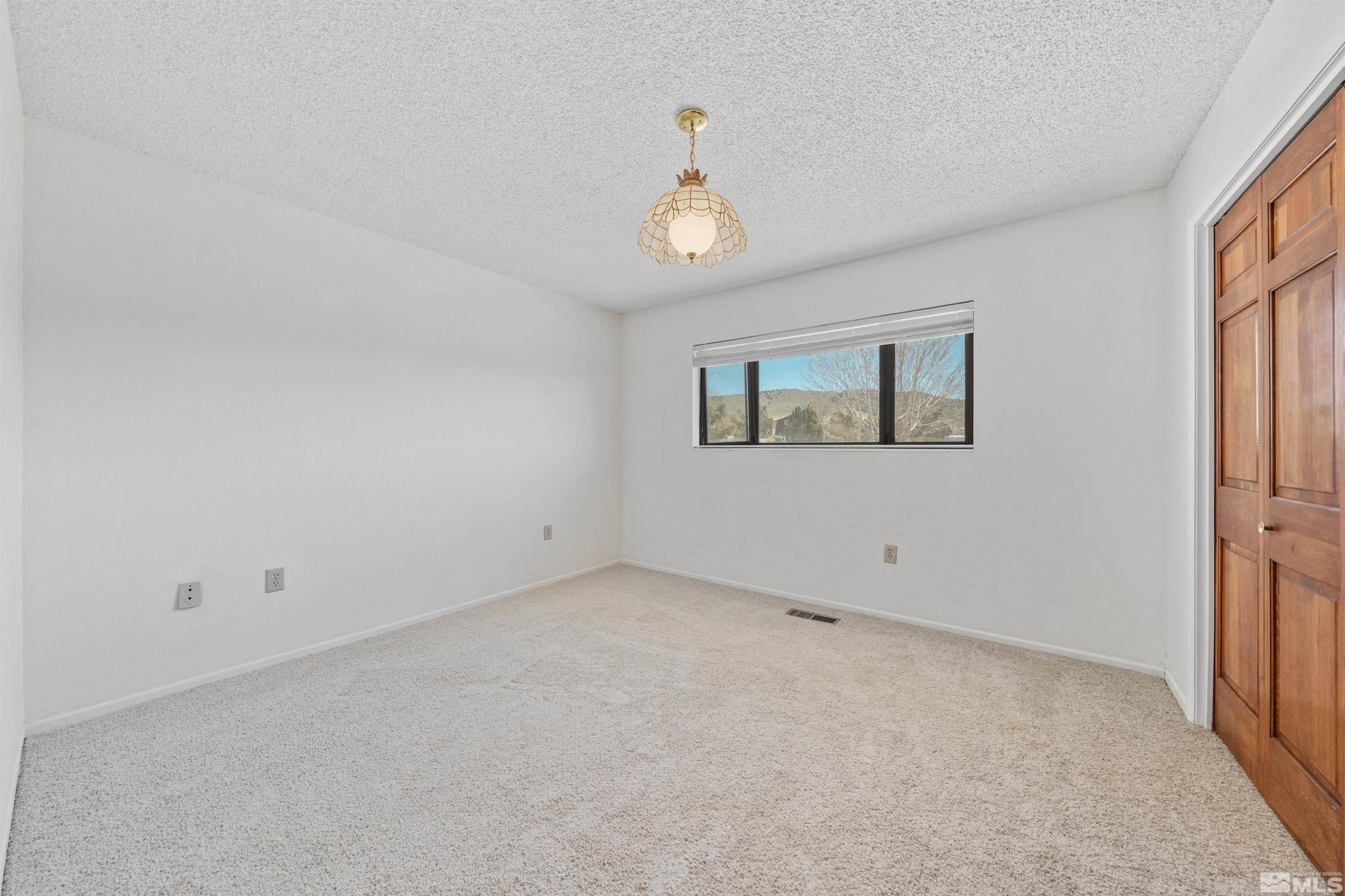 9320 Arrowhead Way Reno, NV 89506 - Photo 26 of 39 an empty room with a window
