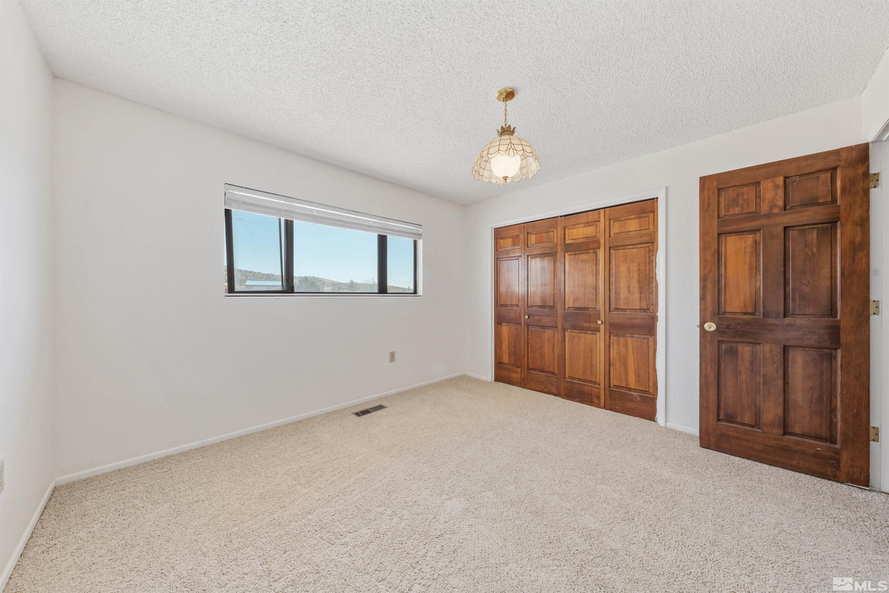 9320 Arrowhead Way Reno, NV 89506 - Photo 27 of 39 a view of an empty room with closet area