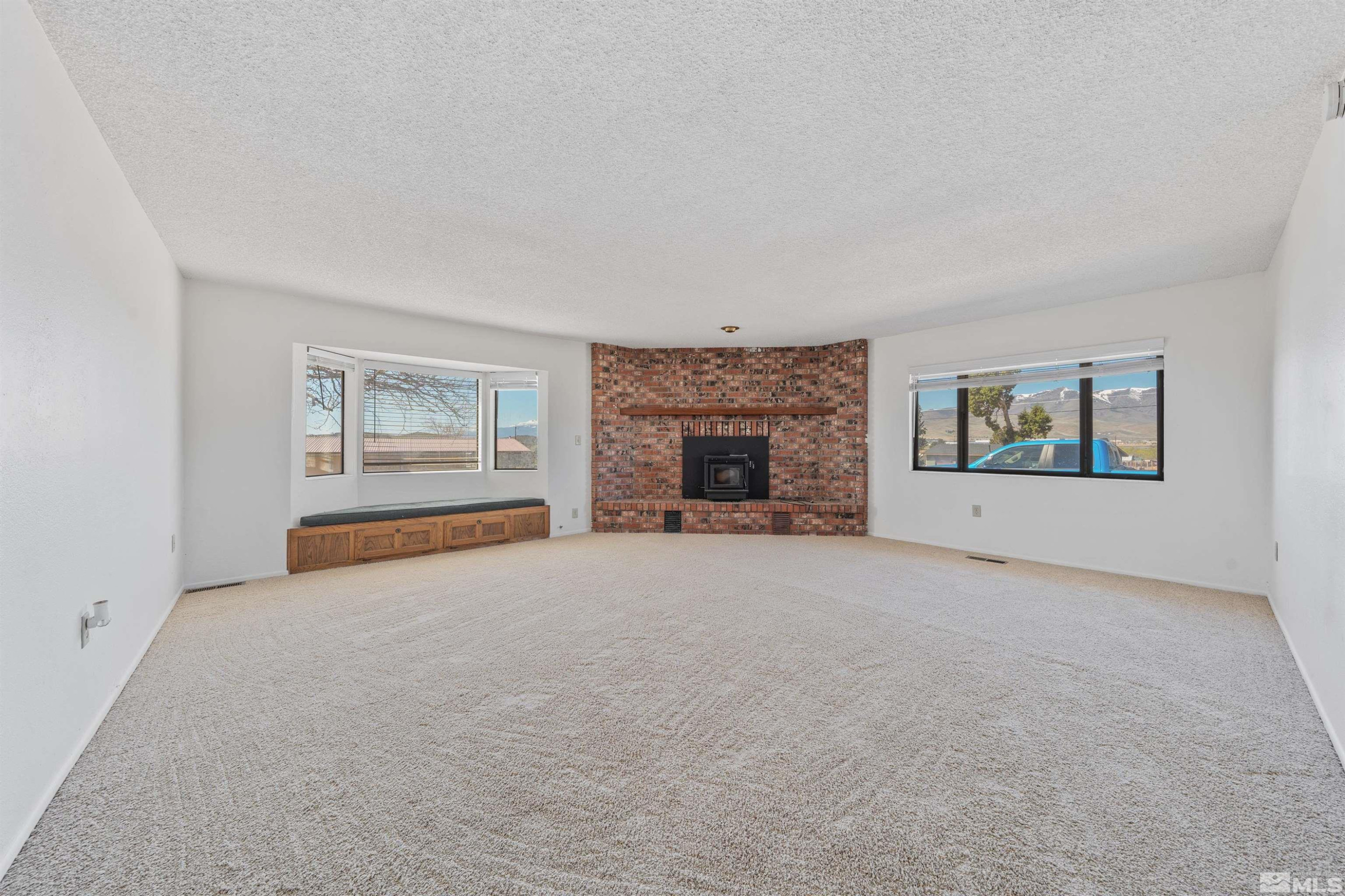 9320 Arrowhead Way Reno, NV 89506 - Photo 4 of 39 an empty room with windows and fireplace