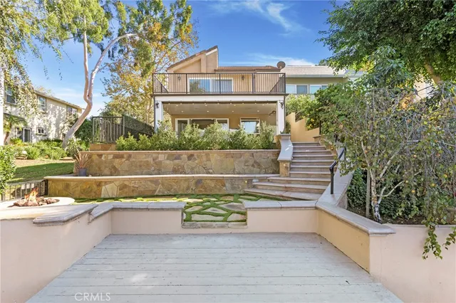 a view of a terrace with a bench and chairs