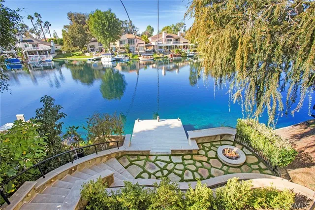 a view of a water pond with sitting area
