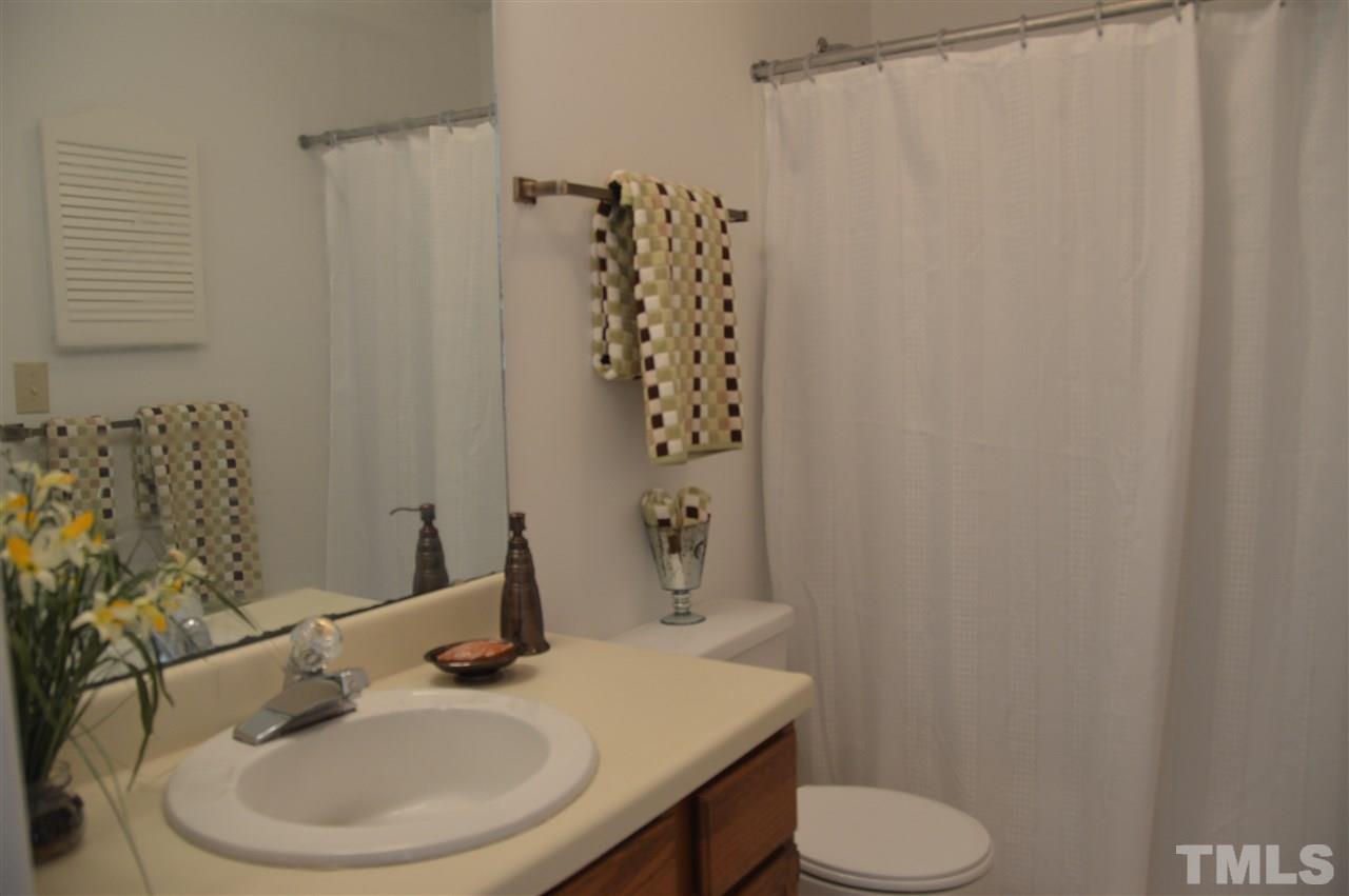 1514 Ferncliff Circle Raleigh, NC 27609 - Photo 14 of 18 a bathroom with a sink a toilet and shower curtain