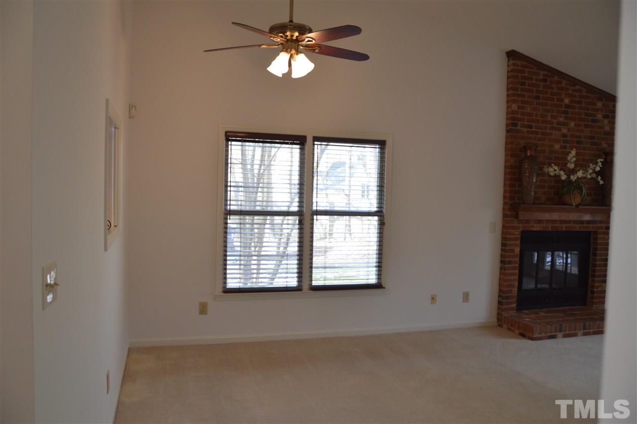 1514 Ferncliff Circle Raleigh, NC 27609 - Photo 8 of 18 an empty room with chandelier fan