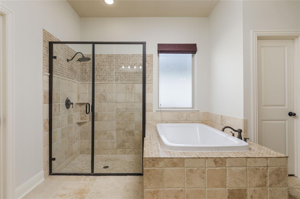 2205 State Boulevard McKinney, TX 75071 - Photo 17 of 40 Primary bathroom features a large garden tub and separate shower.