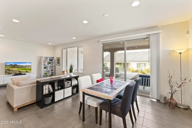 a kitchen with stainless steel appliances kitchen island granite countertop a refrigerator a sink a stove and white cabinets with wooden floor