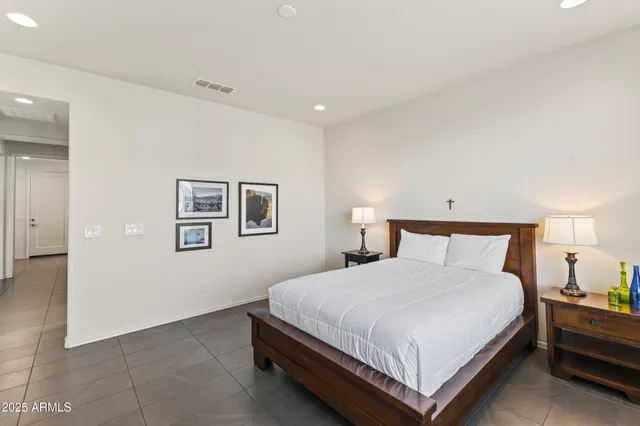 a spacious bedroom with a bed and a window