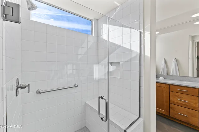 a bathroom with a shower and a glass door