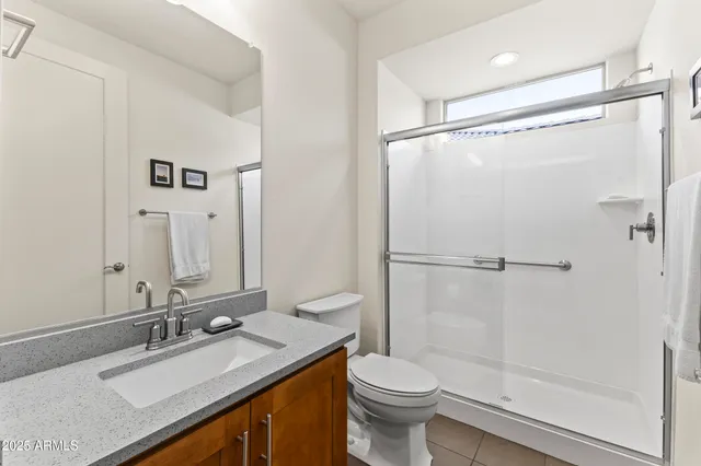 a bedroom with a bed and a refrigerator