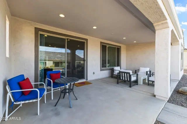 a view of an empty room with furniture and a window