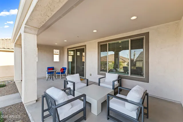 a living room with furniture and a floor to ceiling window