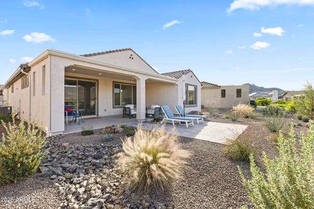 a swimming pool with outdoor seating and patio