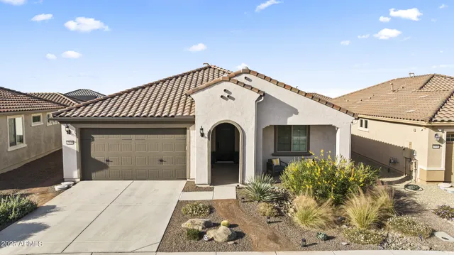a view of a house with backyard porch and sitting area