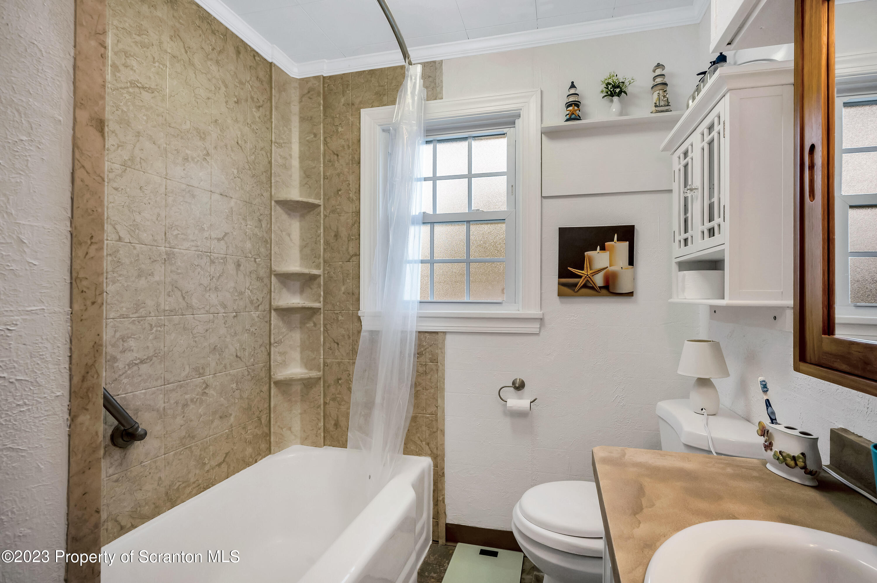 709 Meade Street Throop, PA 18512 - Photo 12 of 37 a bathroom with a sink toilet and shower