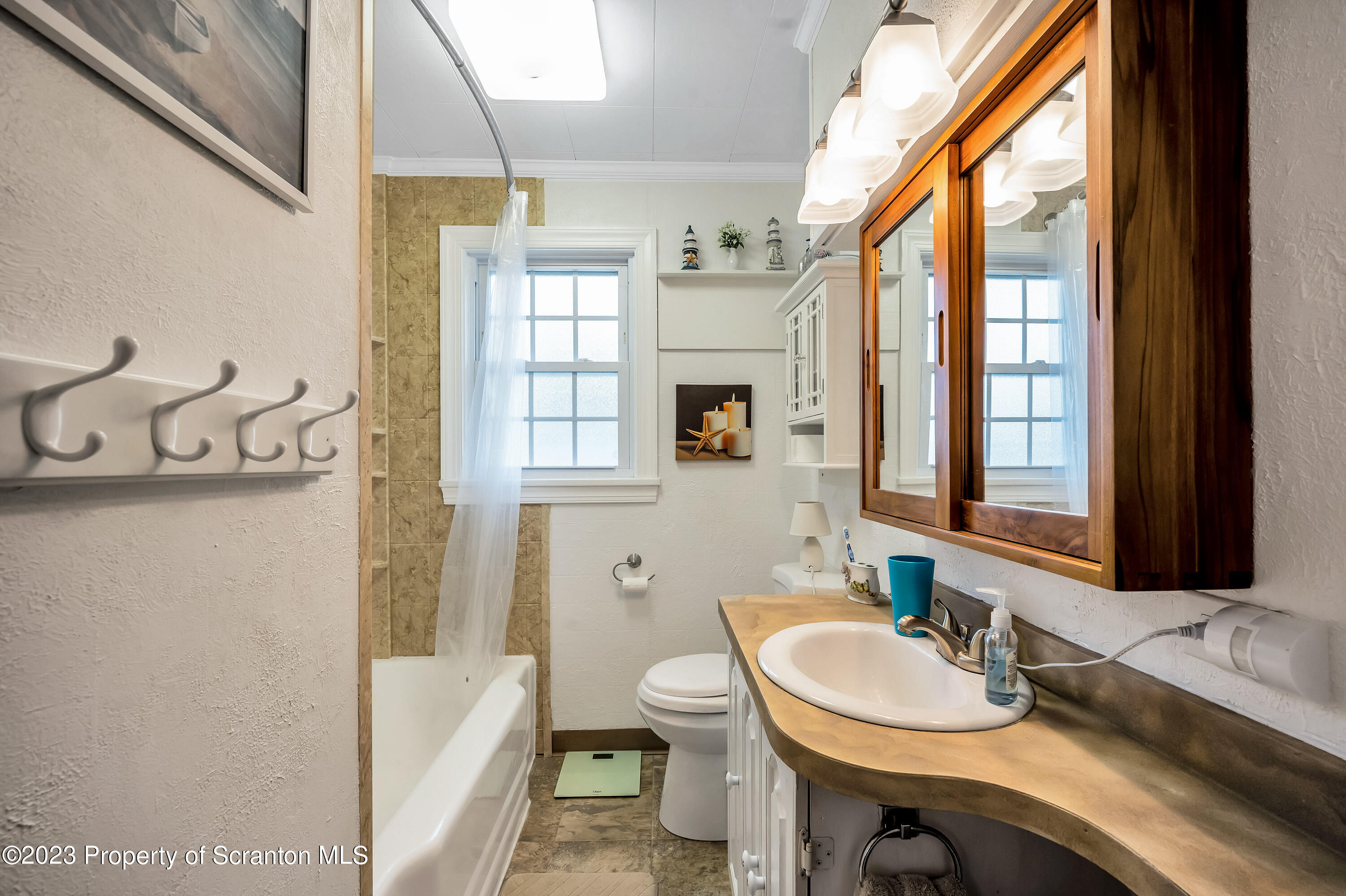 709 Meade Street Throop, PA 18512 - Photo 13 of 37 a bathroom with a sink a toilet and tub