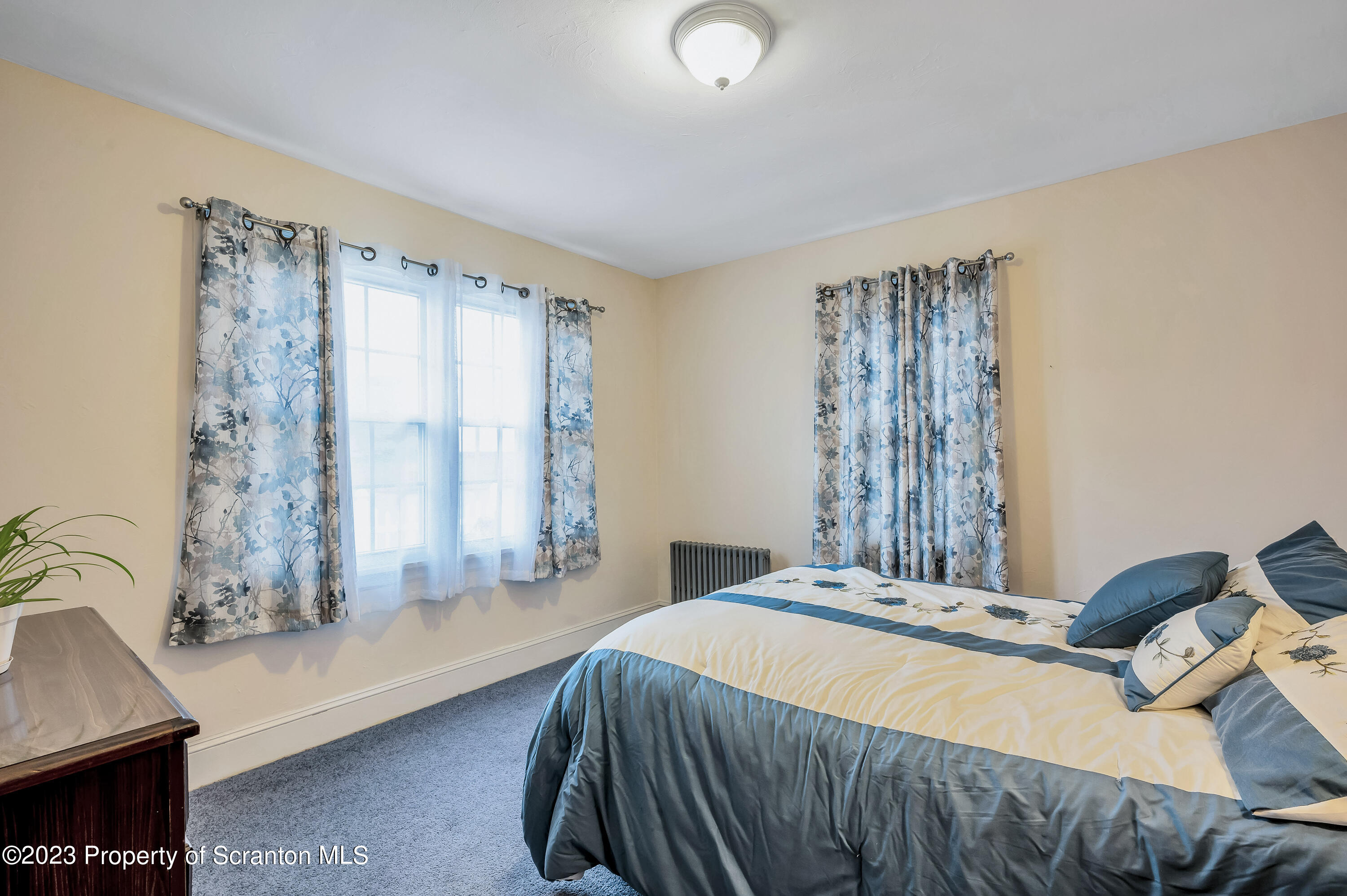 709 Meade Street Throop, PA 18512 - Photo 15 of 37 a bedroom with a bed and a window