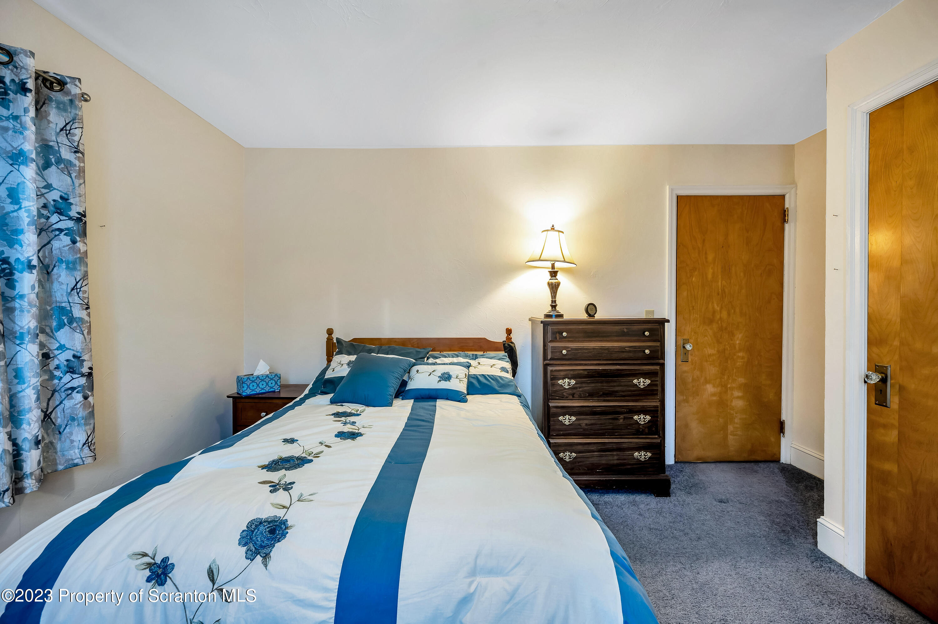 709 Meade Street Throop, PA 18512 - Photo 16 of 37 a bed sitting in a bedroom and table