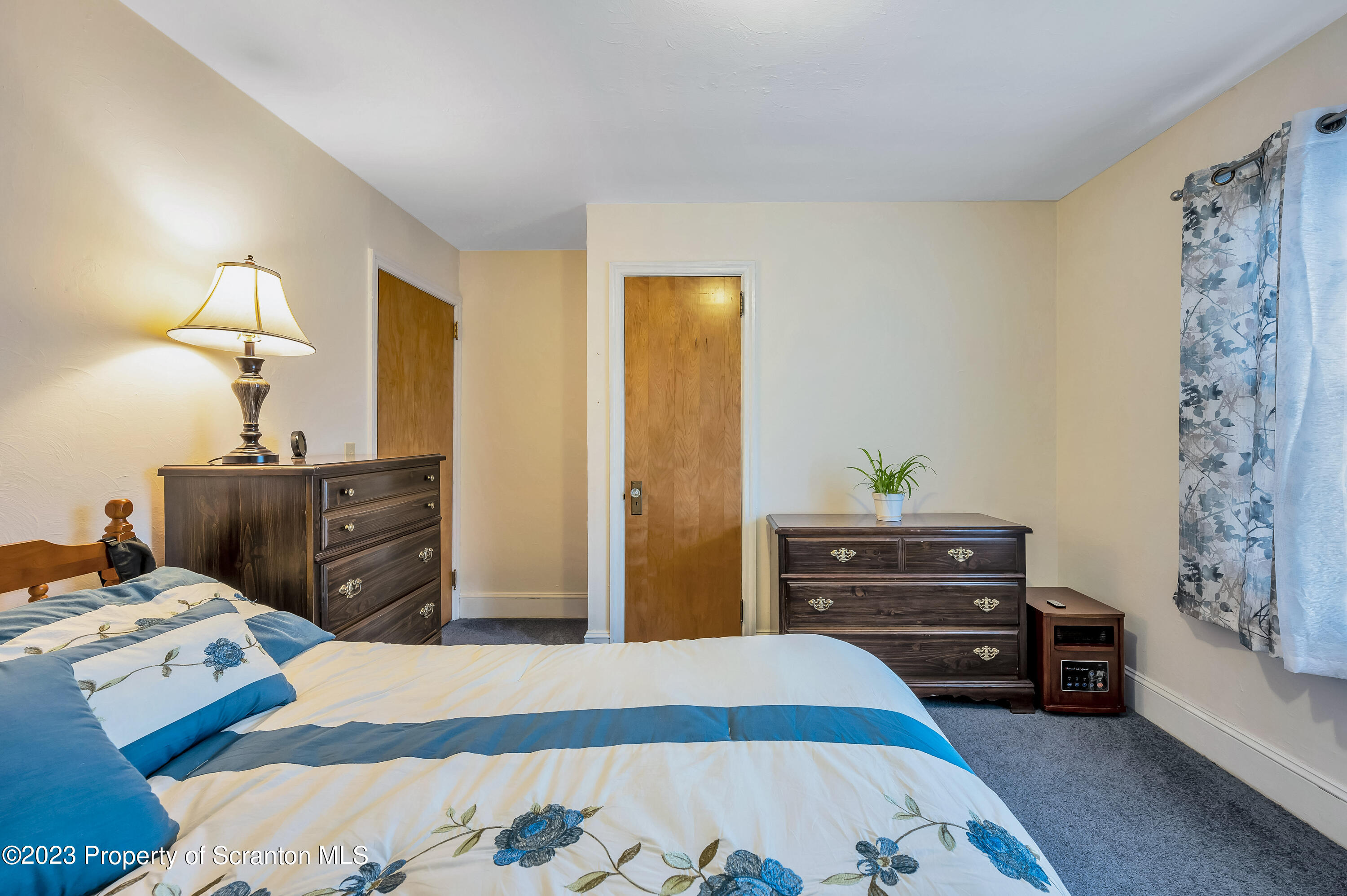 709 Meade Street Throop, PA 18512 - Photo 17 of 37 a bedroom with a bed and a dresser